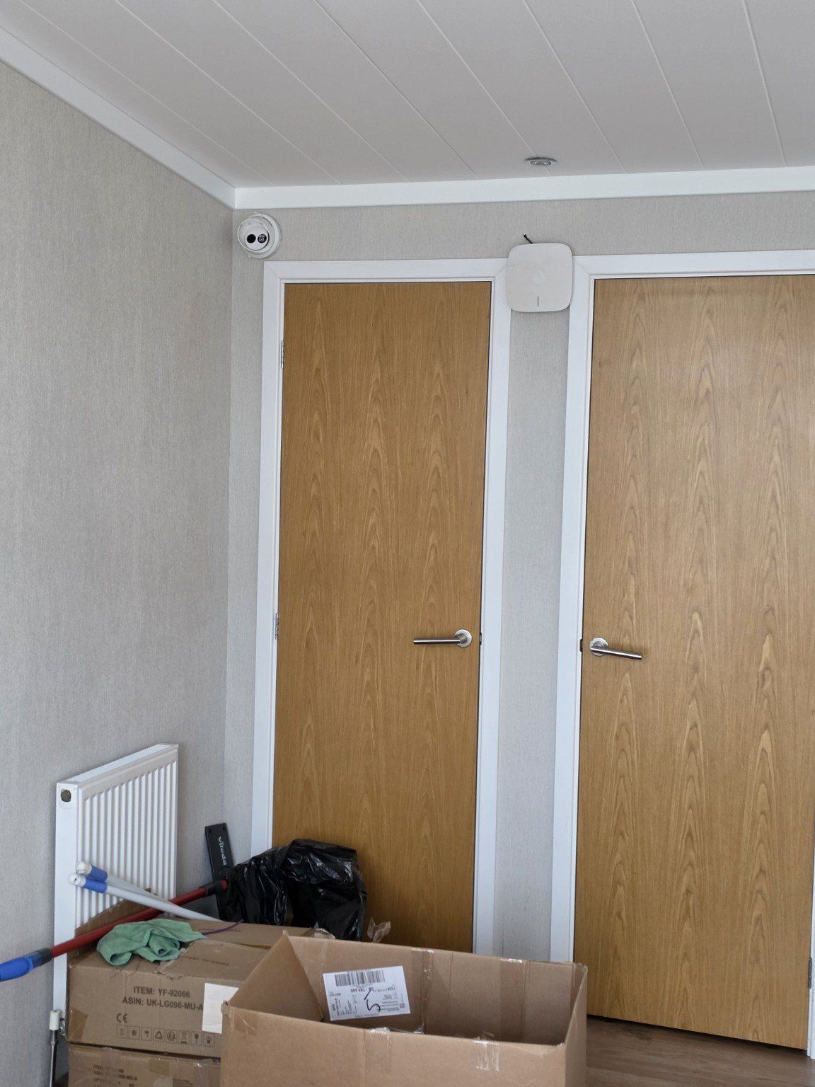 A ceiling-mounted business Wi-Fi access point installed inside a Cornwall property